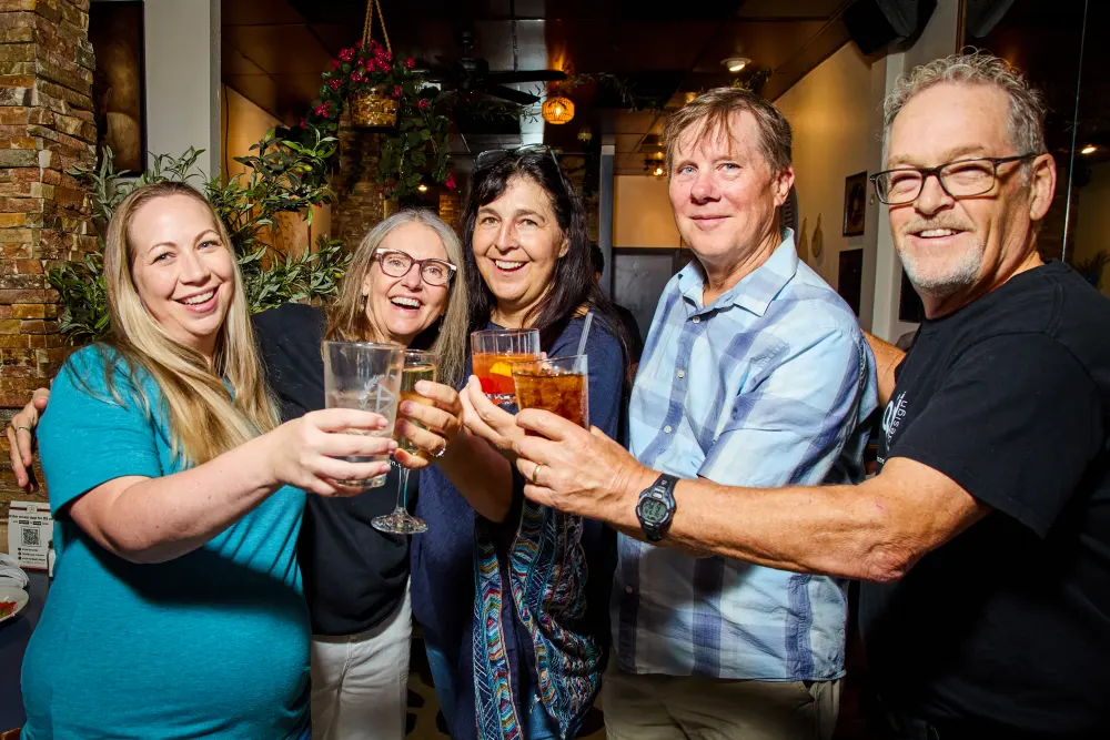 Guests clinking their glasses together at kickoff night