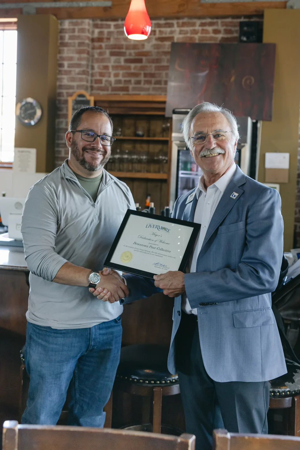 Nick Martinez and Mayor John Marchand holding the Declaration of Welcome