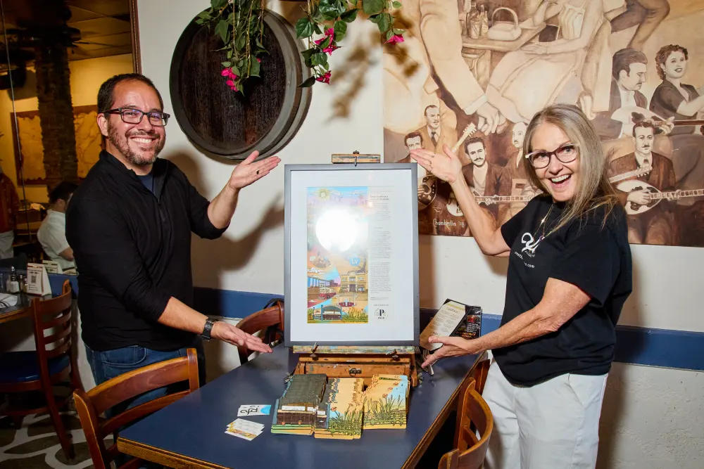 Nick and Annette presenting the framed Livermore Coaster Passport artwork
